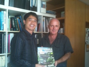 A delegate buys a signed copy of Sustainable House